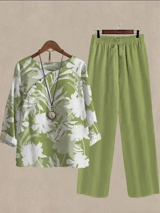 Mono de dos piezas con manga larga, estampado vegetal verde y escote redondo.
