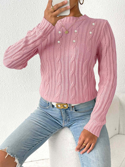 Elegante jersey con estampado tejido y delicados detalles de perlas